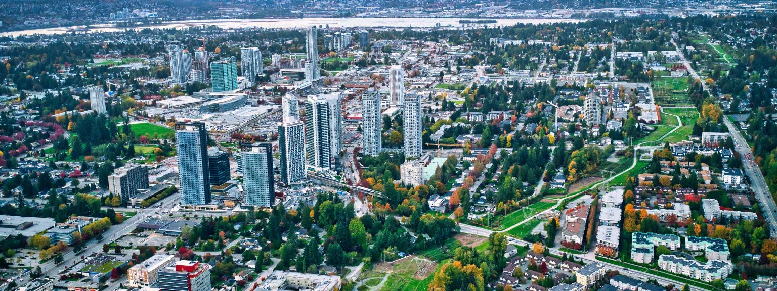 Aerial view of Downtown Surrey with mountains in the background