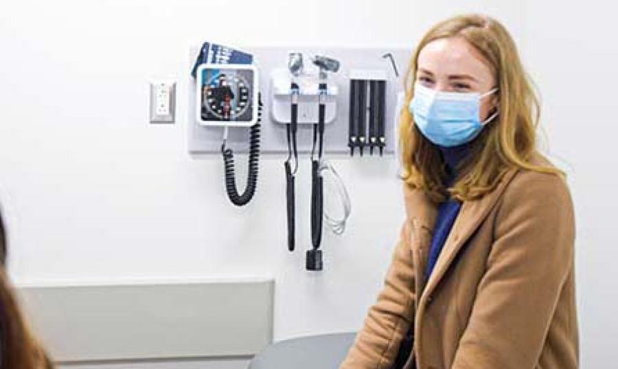 A patient sits in a doctor's office