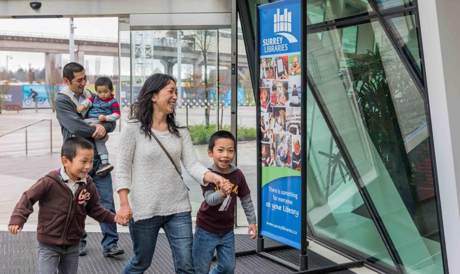 A family walks into the library at City Centre