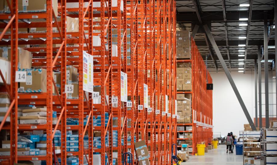 A group of people walking in a warehouse