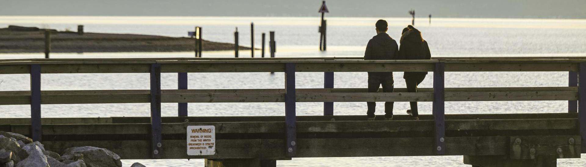 People walking on the pier at Blackie Spit Park in Crescent Beach