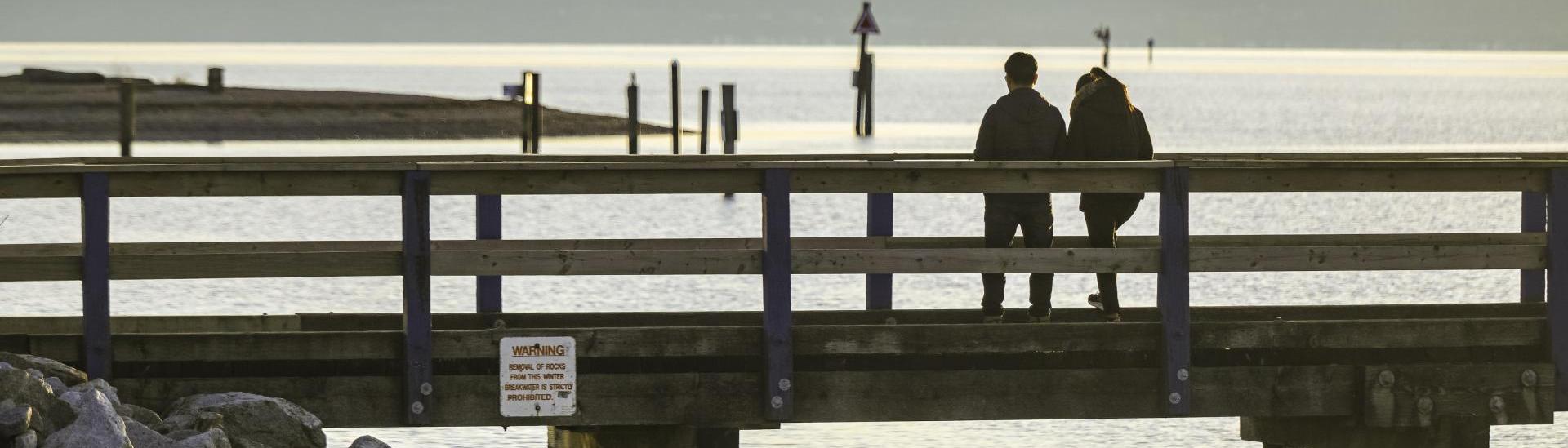 People walking on the pier at Blackie Spit Park in Crescent Beach