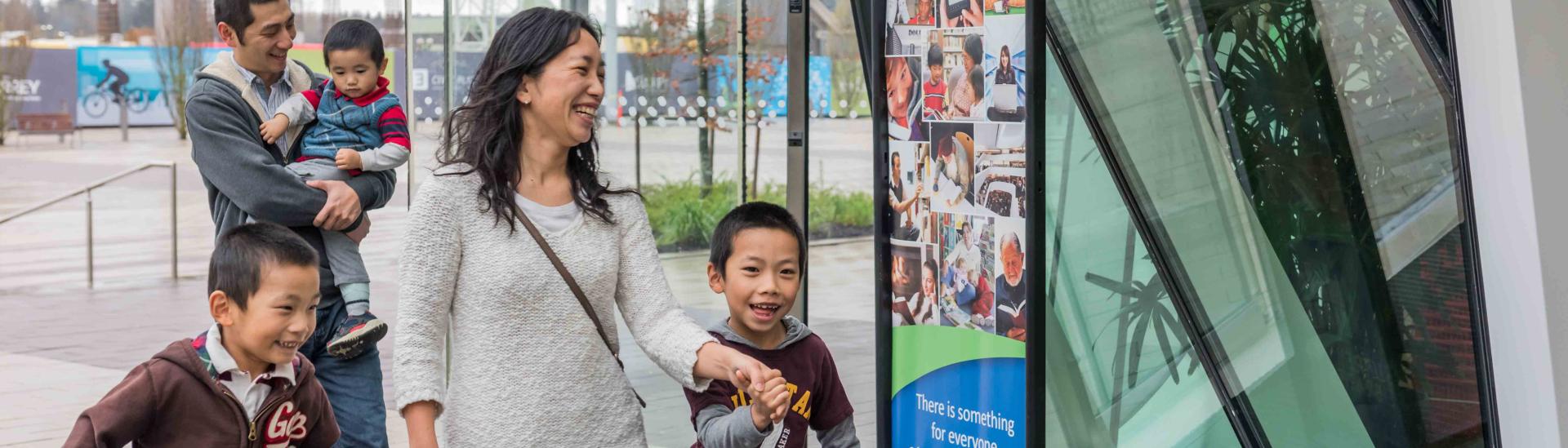 A family walks into the library at City Centre